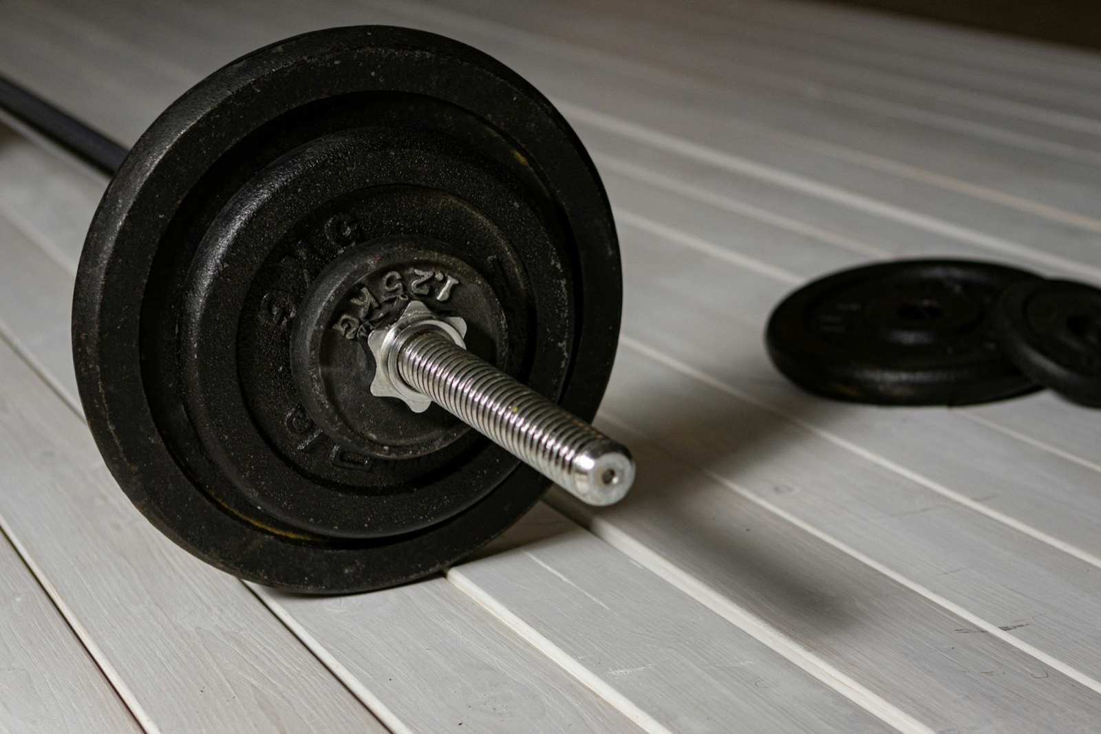 Loaded barbell resting on a gym floor
